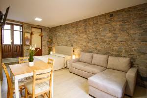 a living room with a couch and a table at Kleosuite Iris Opera Ortigia in Syracuse
