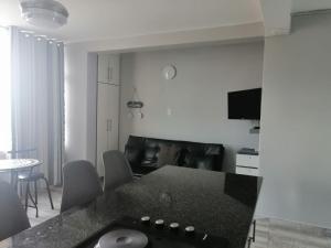 a kitchen and living room with a black counter top at DURBAN BEACHFRONT Tenbury 903 in Durban