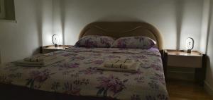 a bedroom with a large bed with two night stands at AVA Apartment Istočno Sarajevo in Lukavica