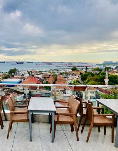 a balcony with tables and chairs and a view of the city at Theodian Hotel in Istanbul