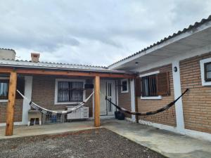 a brick house with a porch with a rope at MARE 3 - DE PEDRA - natureza in Torres