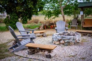 a group of chairs and a table and a fire pit at Pitahaya Glamping in Cabo Rojo +7 photos