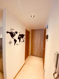 a hallway with a world map on the wall at Tucuman Suite Bariloche in San Carlos de Bariloche