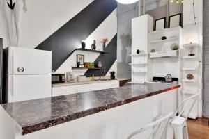a kitchen with white cabinets and a counter at St. Vincent Lofts in Los Angeles