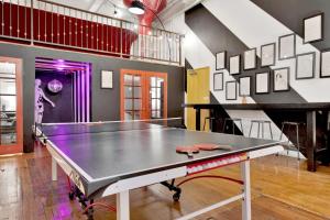 a ping pong table in the middle of a room at St. Vincent Lofts in Los Angeles