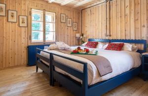 a bedroom with a bed with a tray of fruit on it at QC House - Chalet con Sauna in Santa Caterina Valfurva