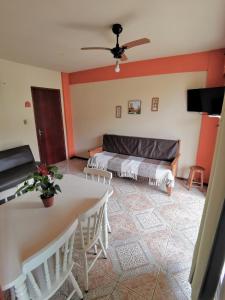 a living room with a bed and a table at Apart da Cachoeira in Florianópolis