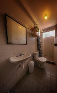 a bathroom with a sink and a toilet at Hotel Willcamayu in Pisac