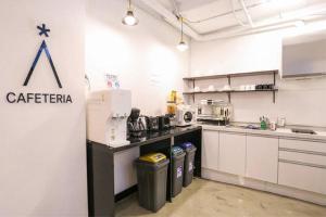 a kitchen with a counter and some trash cans at Starhostel Dongdaemun Suite in Seoul