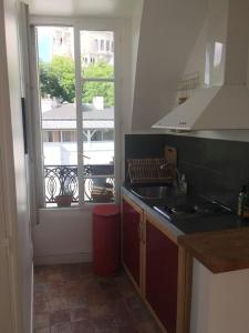 a kitchen with a sink and a window at Amazing view in Montmartre in Paris