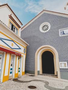 a church with a clock on the front of it at Feel Nazaré - Boutique Apartments in Nazaré