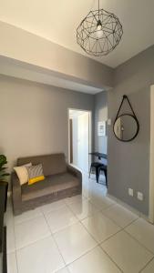a living room with a couch and a table at Apartamento Frente ao Mar Santos II in Santos