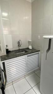 a bathroom with a sink and a counter top at Apartamento Frente ao Mar Santos II in Santos