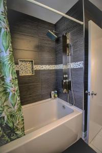 a bathroom with a bath tub and a shower at Charming Cozy Ravine Home Mins to Parks & Lake Entire House in Toronto