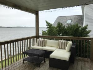 a patio with two chairs and a table on a deck at 14 Clipper on the Bay in Ocean Pines
