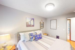 a bedroom with a large bed with blue pillows at Coastal Calm in Lincoln City