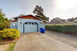 a garage with a blue door in a driveway at Coastal Calm in Lincoln City
