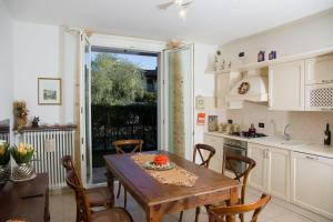 a kitchen and dining room with a table and chairs at Appartamento con giardino e parcheggio privato in Bellagio