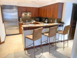 a kitchen with a large island with bar stools at 5 Star Hotel - Exclusive Private Residence in Telluride