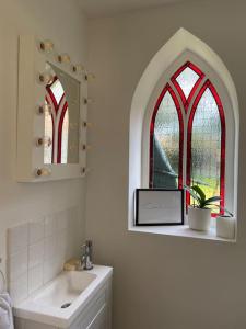 a bathroom with a sink and a window at Coach House near the beach in Great Yarmouth