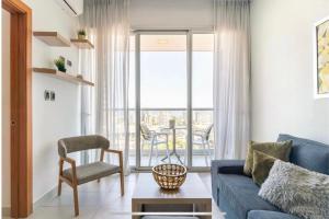 a living room with a blue couch and a balcony at Apartamento S1404 Downtown Santo Domingo in Santo Domingo