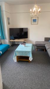 a living room with a couch and a coffee table at Bexhill Luxury Sea Stay Flat 2 in Bexhill