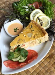 a plate of food with a sandwich and a salad at Inaki Uhi Hotel in Hanga Roa +37 photos