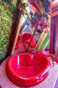 a red bath tub in a room with christmas decorations at Hicksville Pines Chalets & Motel in Idyllwild
