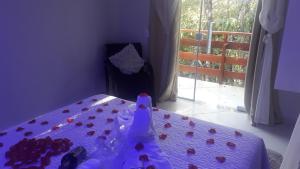 a purple table with a vase on top of it at Parada Di Maria Guest House in Campos do Jordão