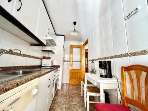 a kitchen with white cabinets and a sink at VAO Holiday Rentals-Santiago De la Ribera in San Javier