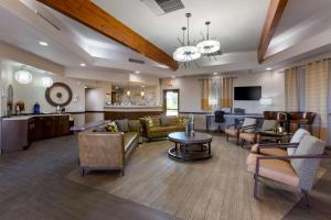 a living room with a couch and a table at Best Western Phoenix Goodyear Inn in Goodyear