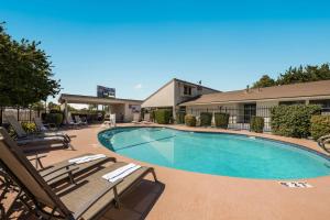 a swimming pool with lounge chairs and a hotel at Best Western Big Country Inn in Coalinga
