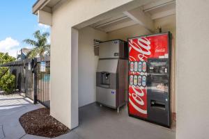 a coca cola vending machine next to a building at Best Western Big Country Inn in Coalinga