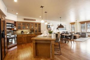 a kitchen and living room with a table and a dining room at 1 Bedroom Condo - The Lodges at Deer Valley condo in Park City