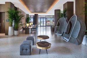 a lobby with chairs and a table and chairs at Radisson Beach Resort Palm Jumeirah in Dubai