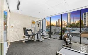 an apartment gym with a view of the city at Avalon Apartments - QStay in Gold Coast