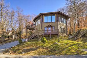 a house on top of a hill with a balcony at Beech Mountain Resort Home with Deck and Hot Tub! in Beech Mountain