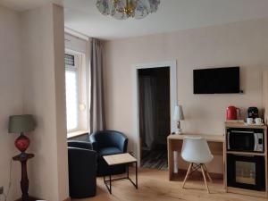a living room with a couch and a chair at cocon des lys in Saint-Louis
