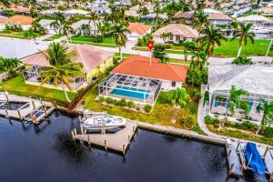 an aerial view of a house with a boat in the water at Menorca Court in Marco Island