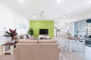 a living room with a couch and a table at Your Keys to Larrakeyah Coastal Comfort with Pool in Larrakeyah