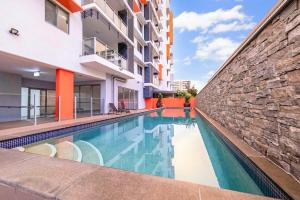 a swimming pool in the middle of a building at Your Keys to Larrakeyah Coastal Comfort with Pool in Larrakeyah