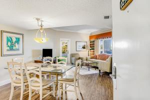 a dining room and living room with a table and chairs at 255-56 Sandcastles in Fernandina Beach
