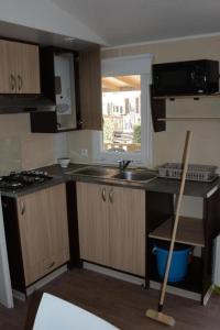 a kitchen with a sink and a stove top oven at PARADIS-ZEN in La Roque-dʼAnthéron