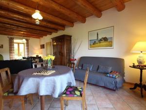 a living room with a table and a couch at Ferme restaurée avec jardin clos et terrasse, proche Puy en Velay - FR-1-582-271 in Le Monastier sur Gazeille