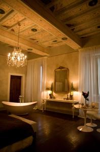 a large bathroom with a tub and a sink at Palazzo Bontadosi Hotel & Spa in Montefalco
