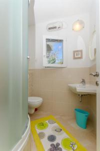 a bathroom with a toilet and a sink at Apartments Vesela in Podaca +26 photos