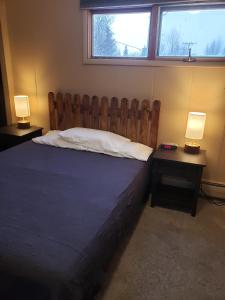 a bedroom with a bed with two lamps on tables at Soldotna Inn in Soldotna