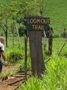 a sign that says look out train on a tree at Malekus Mountain Lodge in Aguas Claras