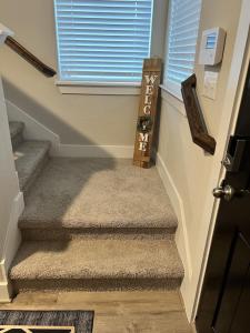 a hallway with stairs with a door and a window at New 3 story home *Seaworld/ Lackland in Helotes