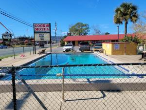 a fence with a pool in front of a store at Cook's Motel in Panama City Beach
